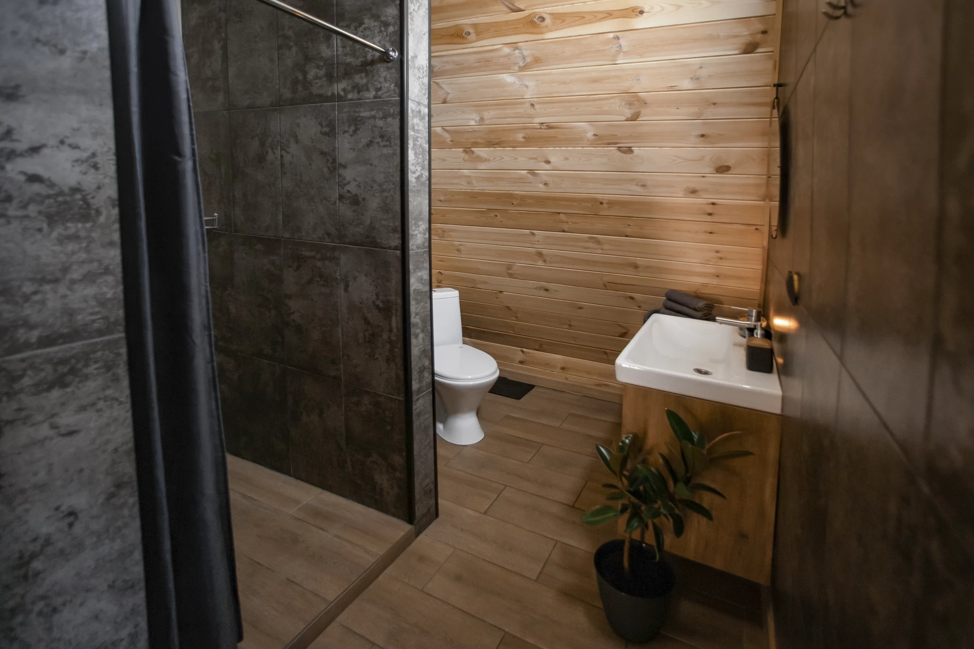 Напольный унитаз с удобной седушкой. Для комфорта предусмотрены мусорное ведро, вешалка для бумаги, освежитель воздуха и туалетный ершик.